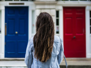 girl standing in front of two different doors