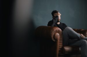 stressed man sitting on couch