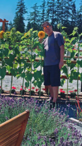 man standing by a sunflower