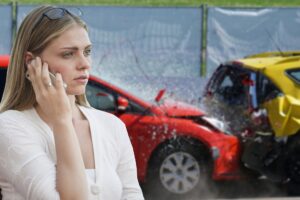 girl making phone call after car crash