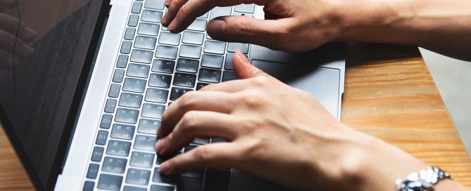 hands typing on keyboard