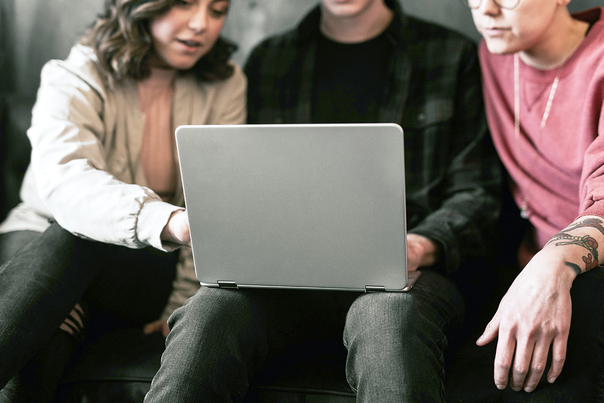 people looking at a laptop screen