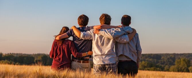 group of young people with arms around each other