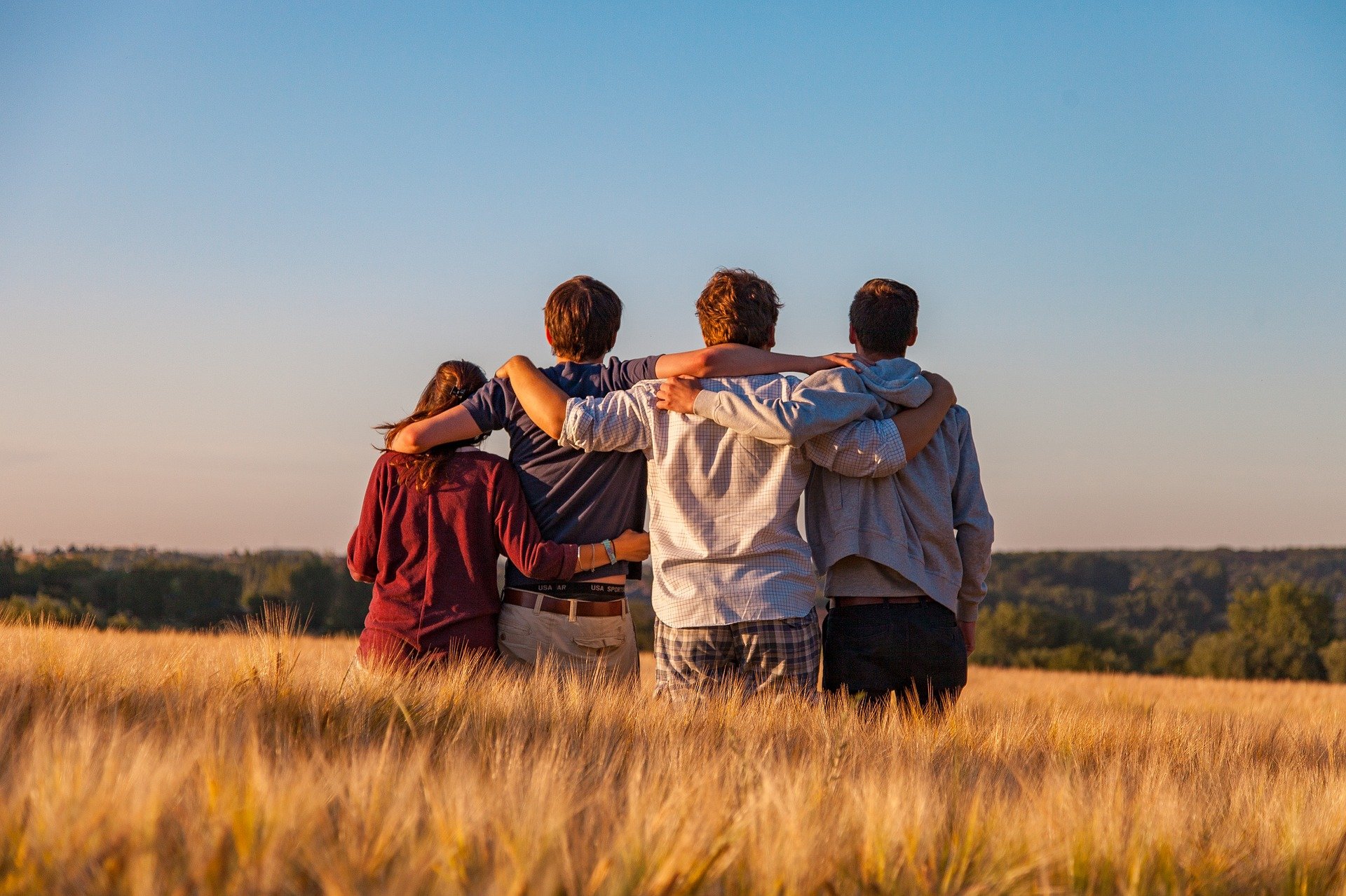 group of young people with arms around each other