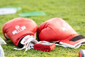 Red boxing gloves on the ground