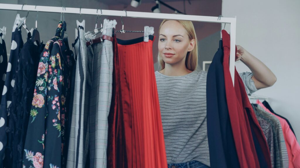 Woman looking through a rack of clothing.